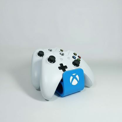 Two black gaming controllers with Xbox logo on a white background